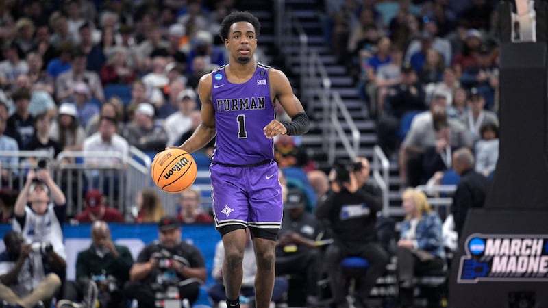 Furman guard JP Pegues (1) brings the ball up the court during the second half of a...