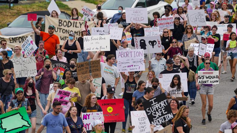 FILE - Abortion-rights protestors march between the Indiana Statehouse and the Indiana State...