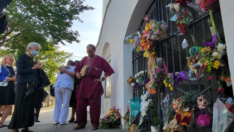 People came by to pay their respects throughout the day, even placing flowers at the church’s...