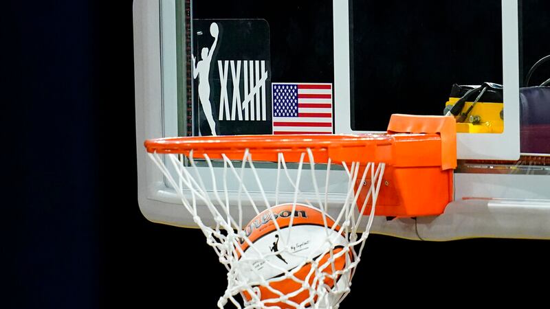 A logo on the backboard marks the 25th anniversary of the WNBA as the Los Angeles Sparks warm...