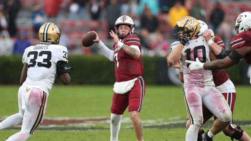 South Carolina quarterback Spencer Rattler (7) throws a pass under press from Vanderbilt...