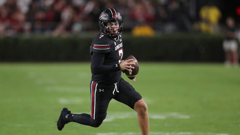 South Carolina quarterback Spencer Rattler (7) runs for a first down during the first half of...