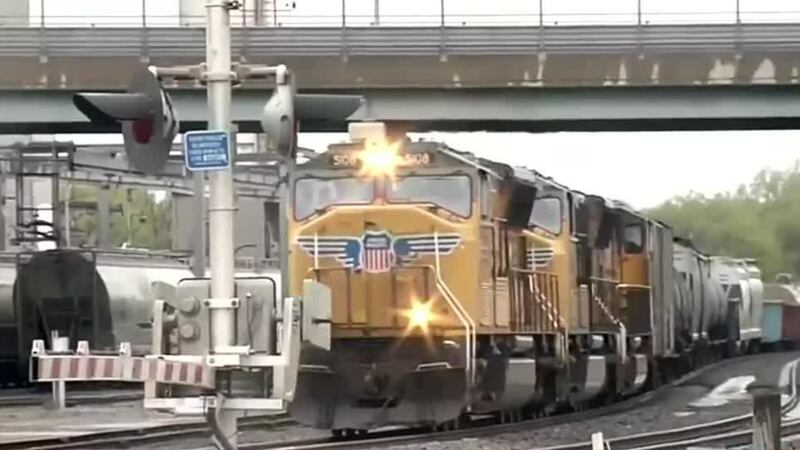 FILE - Handfuls of workers gathered outside railyards across the country Wednesday in pickets...